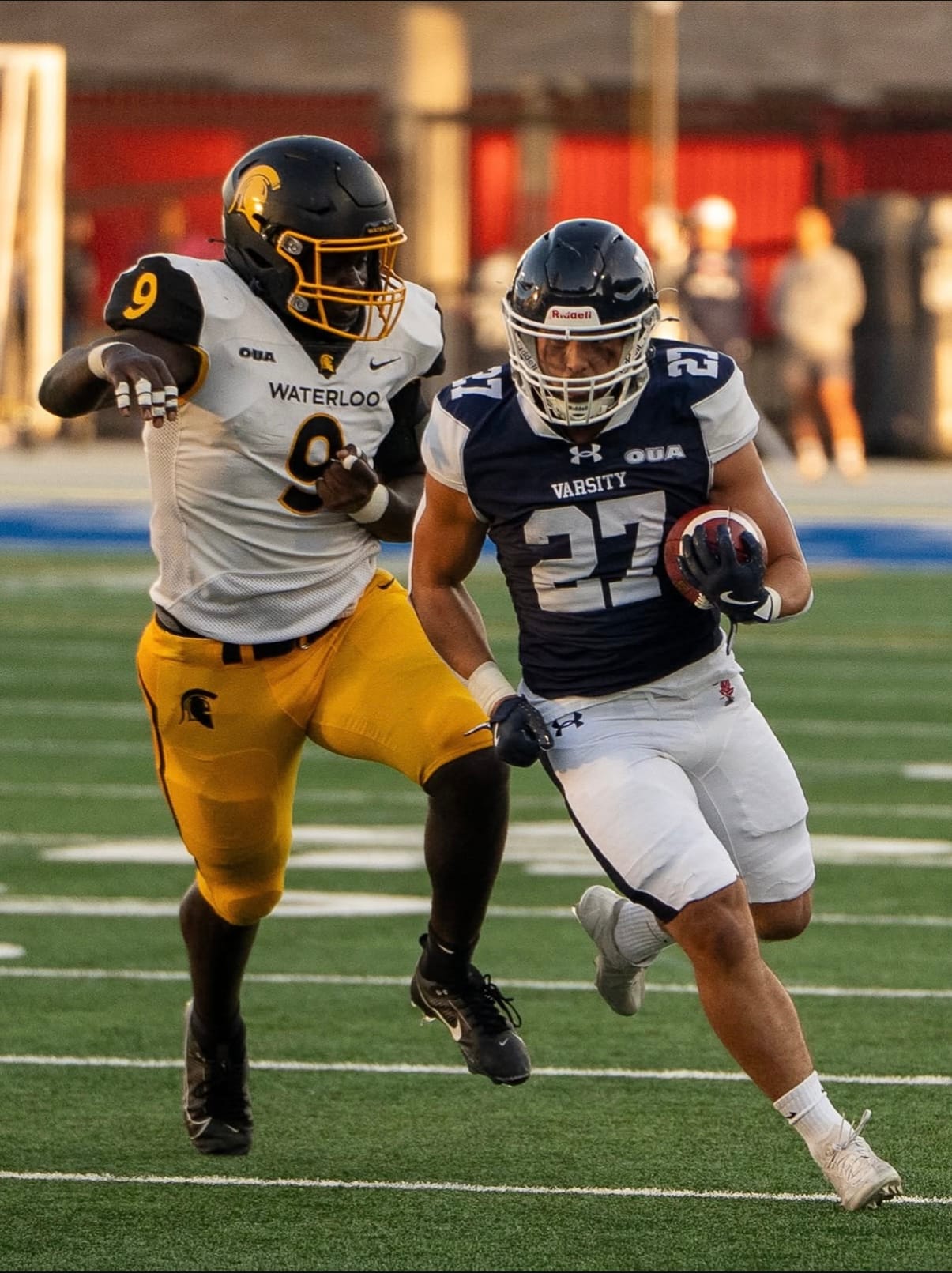 A player carrying the ball on a football field
